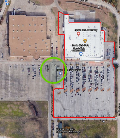 Satellite image of a standalone building with a red outline showing the polygon drawn around the parking lots indicating the extent.